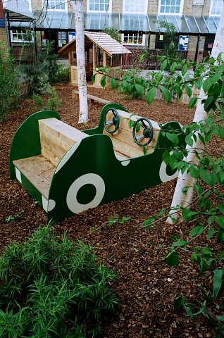 School play area with play car, western red cedar play house and balance beam with play bark surfacing