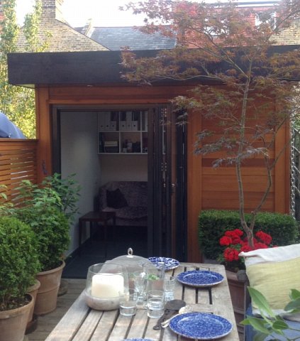 Small garden office with aluminium bi-fold doors