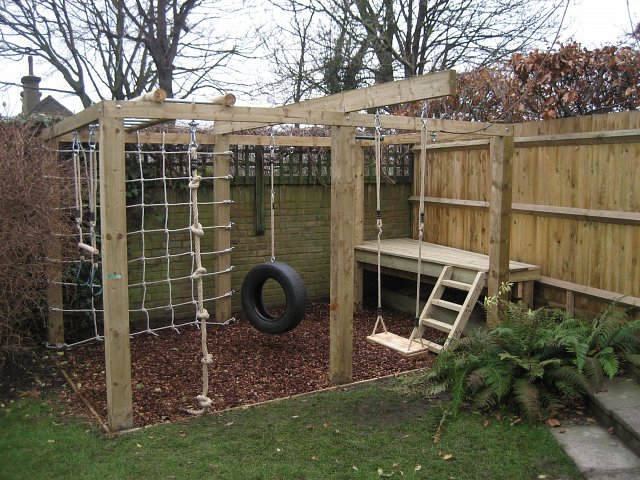 Children's playframe with monkey bars, swing, knotted rope, climbing net and platform