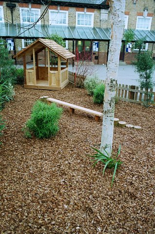 School play area with western red cedar play house, play bark, cedar balance beam and stepping logs